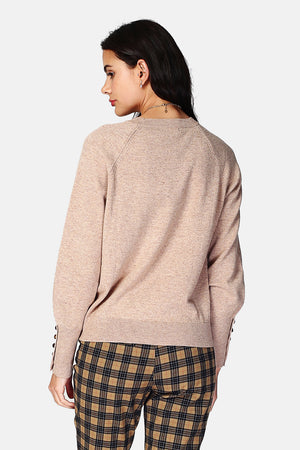 Wide sweater with round neckline and slightly puffed long sleeves with button placket at the bottom of the sleeve