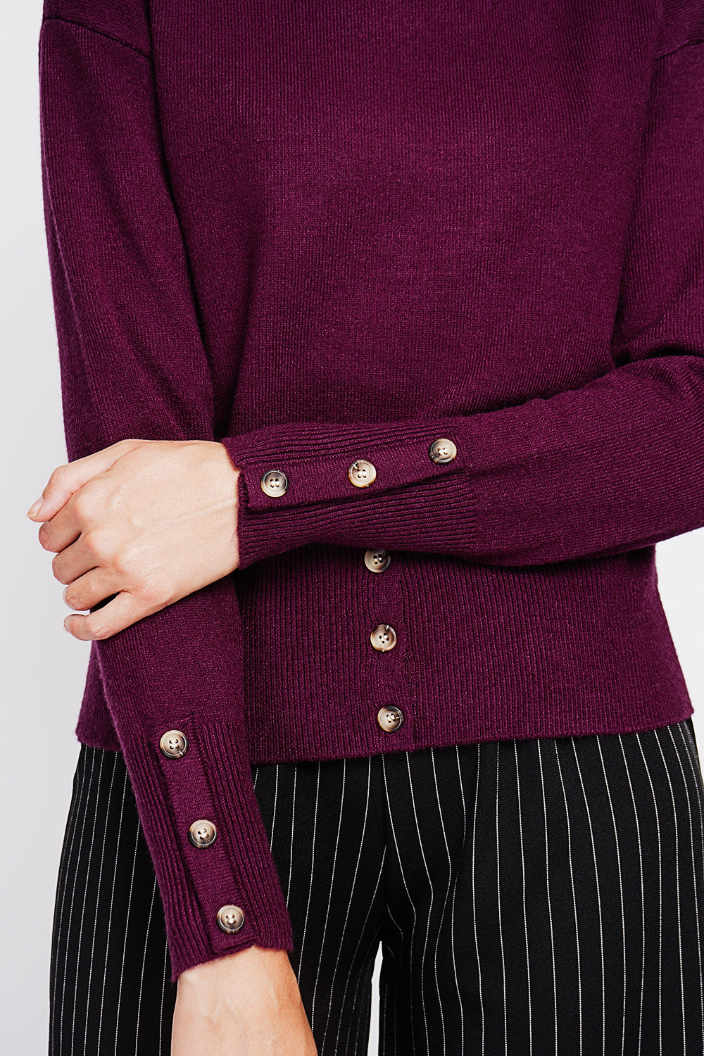 Turtleneck sweater with low front buttoned and long sleeves