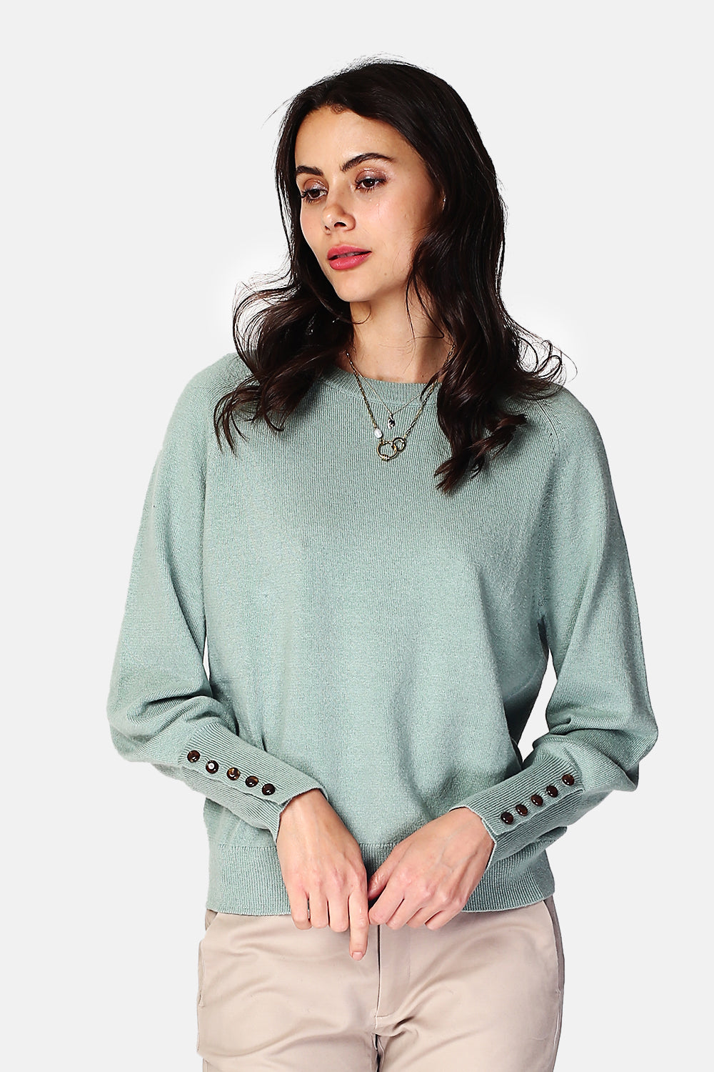 Wide sweater with round neckline and slightly puffed long sleeves with button placket at the bottom of the sleeve