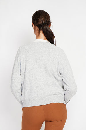 Crew neck oversized cut vest with button placket at the bottom of the long sleeves
