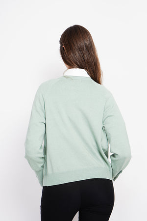 Crew neck oversized cut vest with button placket at the bottom of the long sleeves