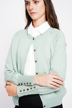 Crew neck oversized cut vest with button placket at the bottom of the long sleeves