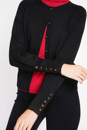 Crew neck oversized cut vest with button placket at the bottom of the long sleeves