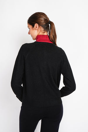 Crew neck oversized cut vest with button placket at the bottom of the long sleeves