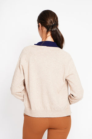Crew neck oversized cut vest with button placket at the bottom of the long sleeves
