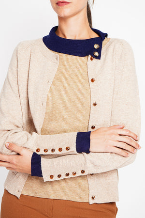Crew neck oversized cut vest with button placket at the bottom of the long sleeves