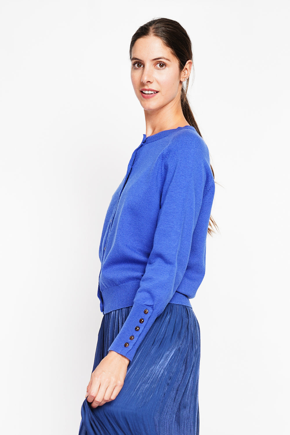 Crew neck oversized cut vest with button placket at the bottom of the long sleeves