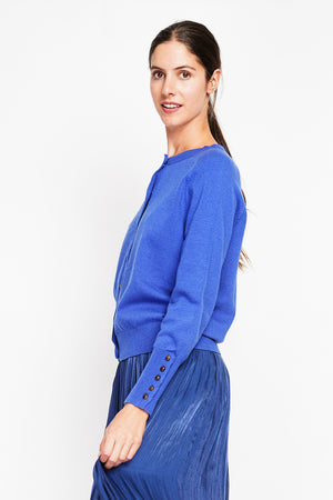 Crew neck oversized cut vest with button placket at the bottom of the long sleeves
