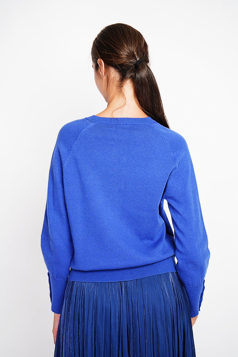 Crew neck oversized cut vest with button placket at the bottom of the long sleeves