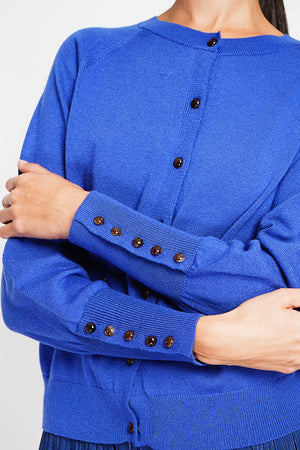 Crew neck oversized cut vest with button placket at the bottom of the long sleeves