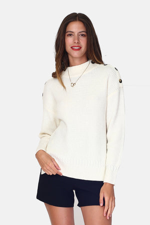 High neck sweater closed by a button placket on the shoulder, on the bottom in cable knit with long sleeves Slits on the sides