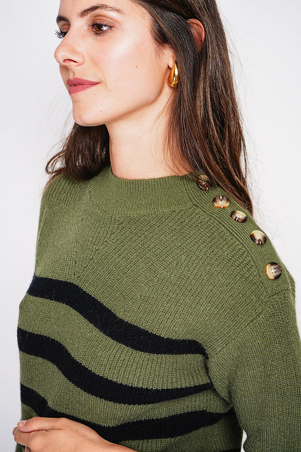 Openwork high neck sweater with buttoned shoulder and long sleeves