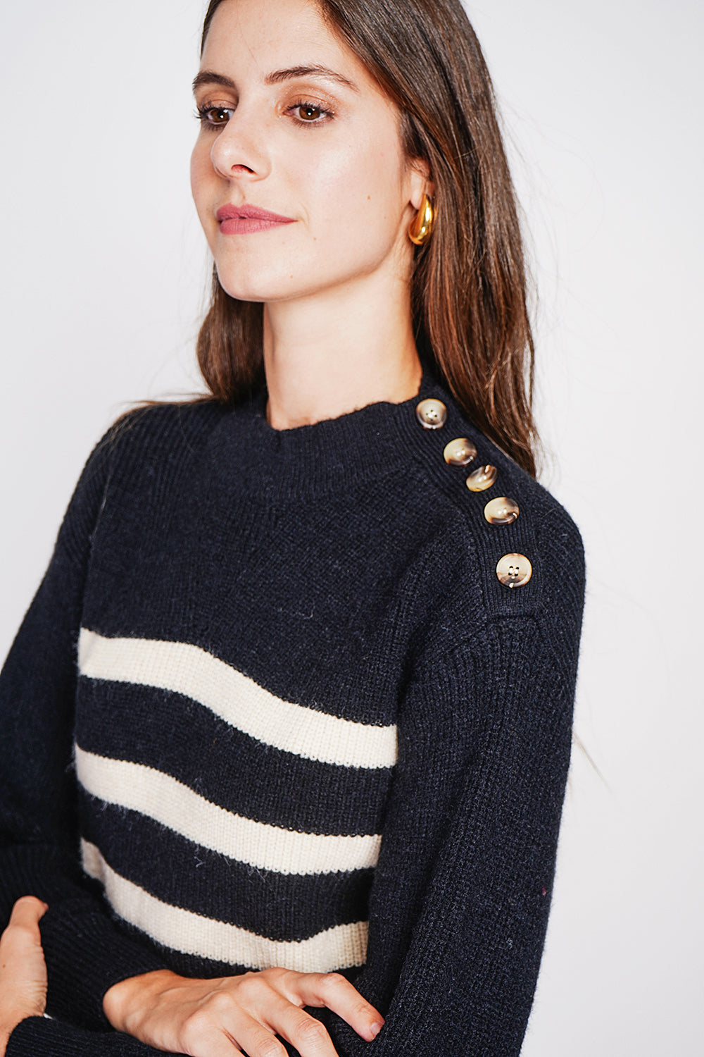 Openwork high neck sweater with buttoned shoulder and long sleeves