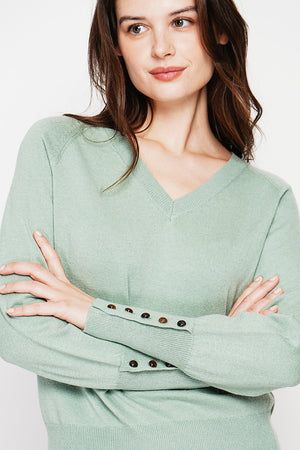 Oversized V-neck sweater with button placket at the bottom of the long sleeves