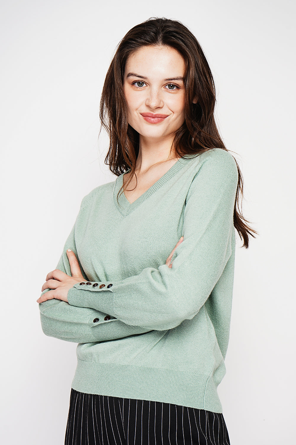 Oversized V-neck sweater with button placket at the bottom of the long sleeves