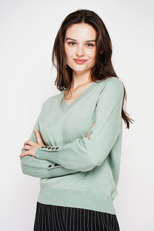 Oversized V-neck sweater with button placket at the bottom of the long sleeves