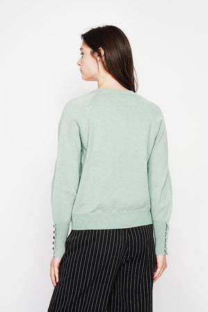 Oversized V-neck sweater with button placket at the bottom of the long sleeves