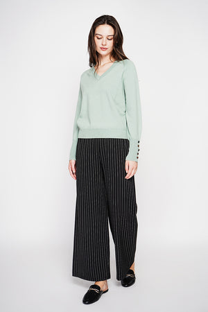 Oversized V-neck sweater with button placket at the bottom of the long sleeves