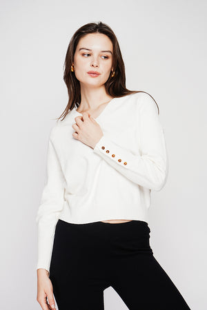 Oversized V-neck sweater with button placket at the bottom of the long sleeves
