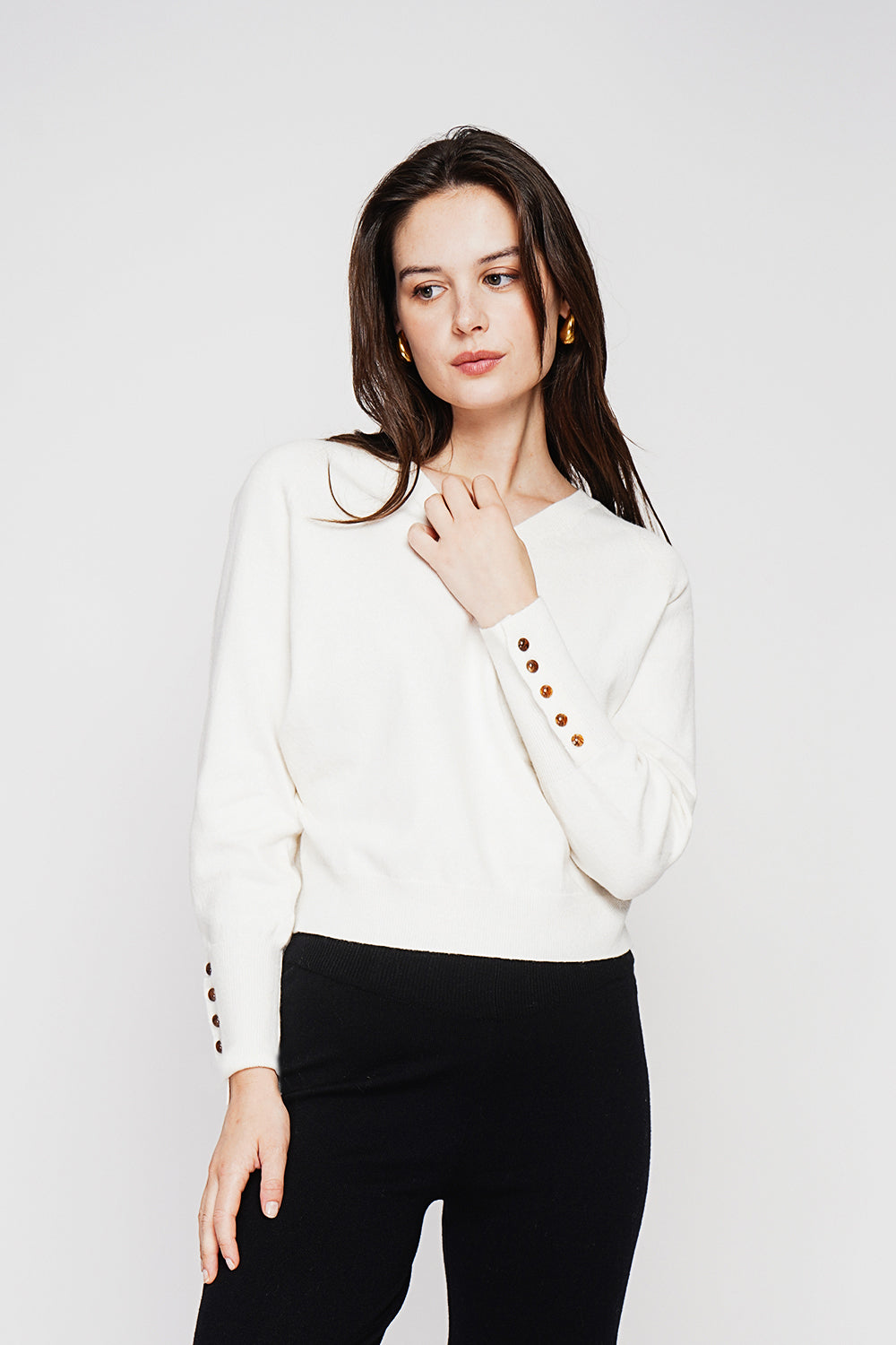 Oversized V-neck sweater with button placket at the bottom of the long sleeves