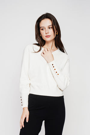 Oversized V-neck sweater with button placket at the bottom of the long sleeves