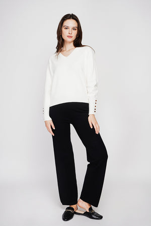 Oversized V-neck sweater with button placket at the bottom of the long sleeves