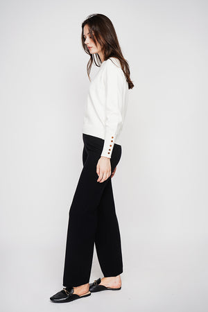 Oversized V-neck sweater with button placket at the bottom of the long sleeves