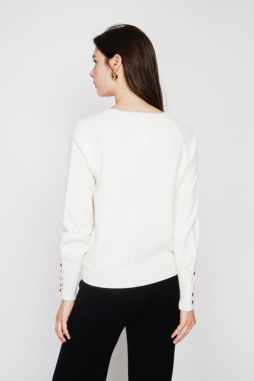 Oversized V-neck sweater with button placket at the bottom of the long sleeves