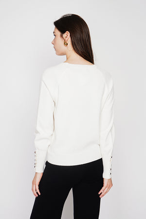 Oversized V-neck sweater with button placket at the bottom of the long sleeves