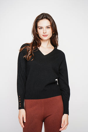 Oversized V-neck sweater with button placket at the bottom of the long sleeves