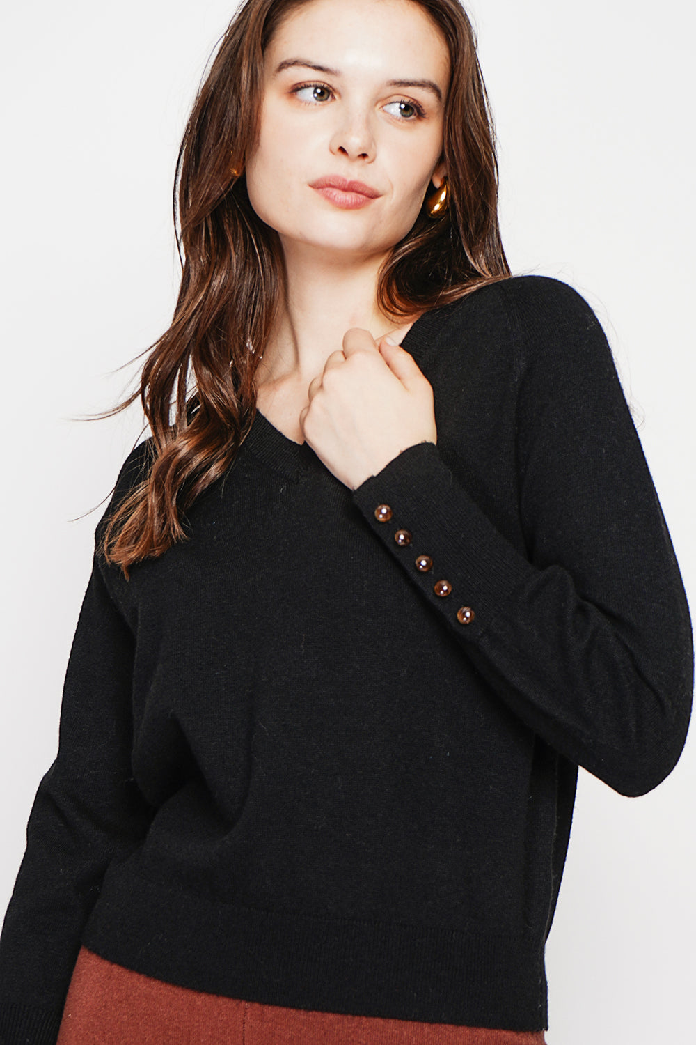 Oversized V-neck sweater with button placket at the bottom of the long sleeves