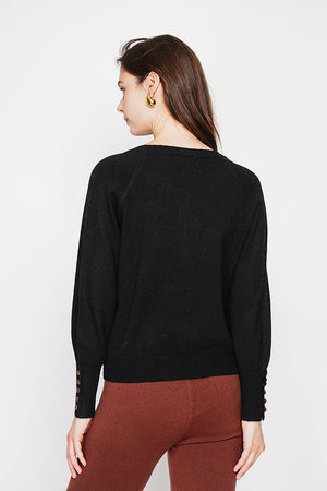 Oversized V-neck sweater with button placket at the bottom of the long sleeves