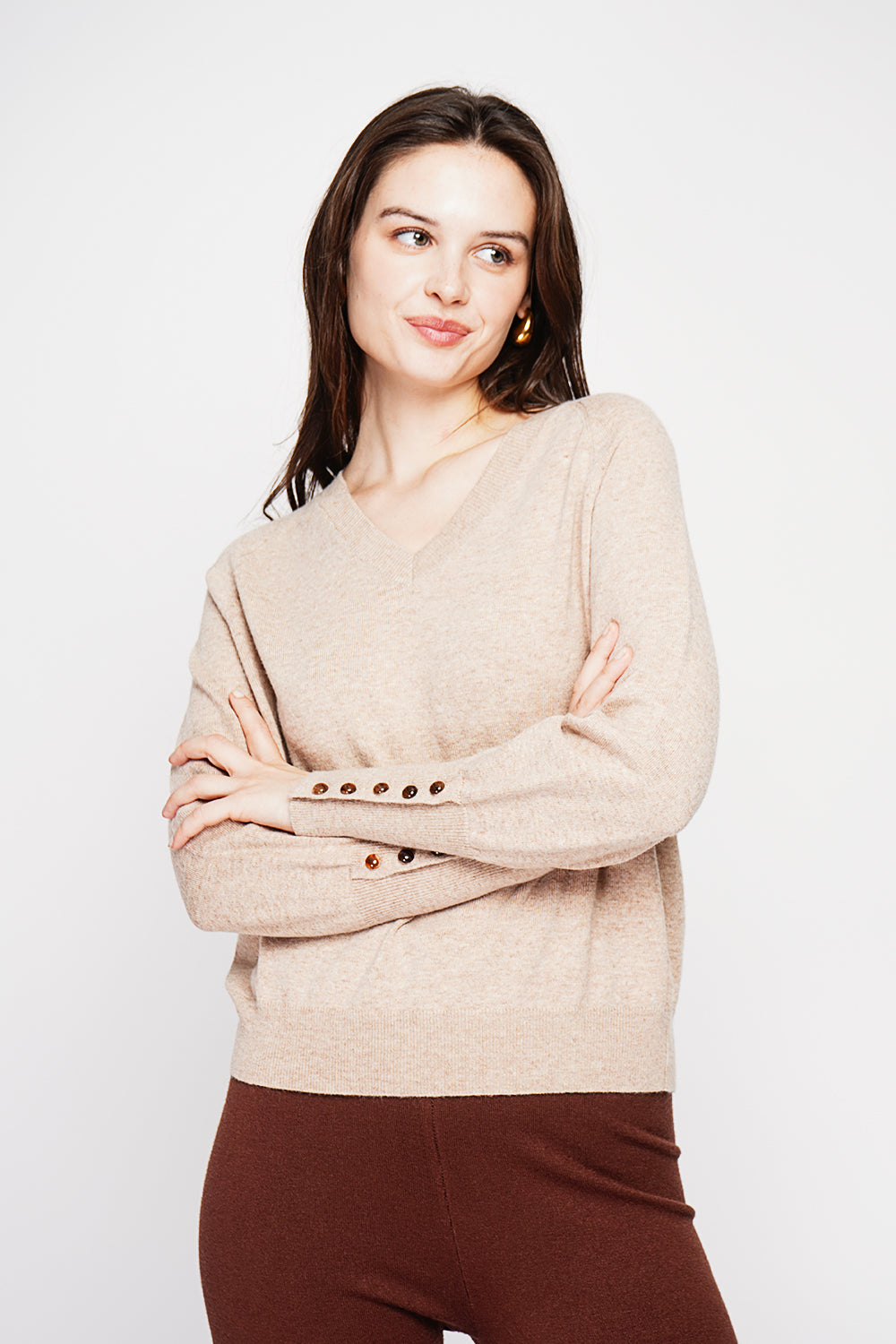 Oversized V-neck sweater with button placket at the bottom of the long sleeves