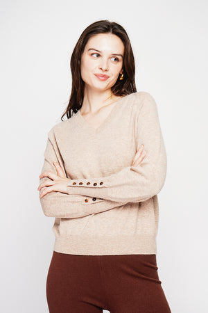 Oversized V-neck sweater with button placket at the bottom of the long sleeves