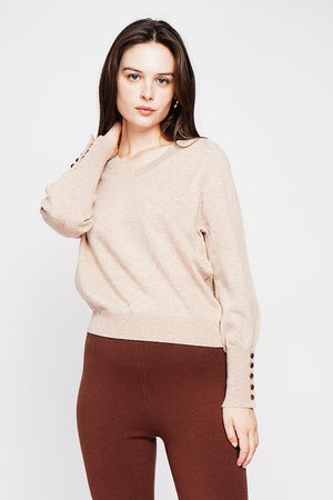 Oversized V-neck sweater with button placket at the bottom of the long sleeves
