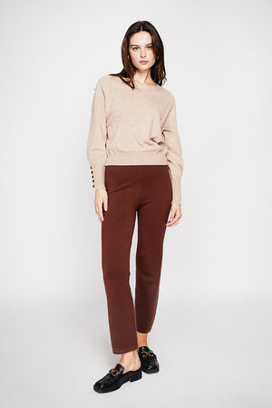 Oversized V-neck sweater with button placket at the bottom of the long sleeves