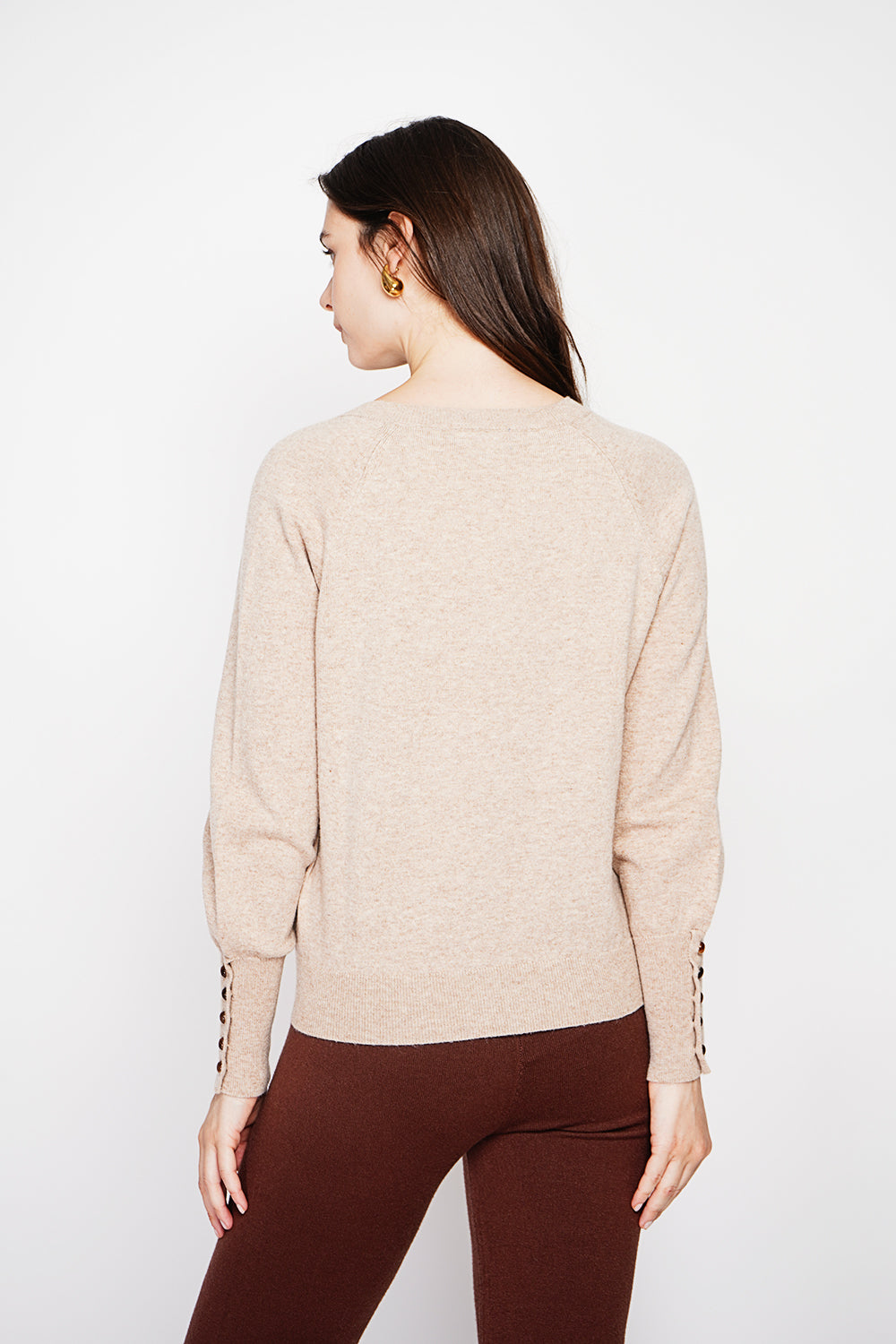 Oversized V-neck sweater with button placket at the bottom of the long sleeves
