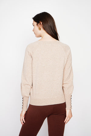 Oversized V-neck sweater with button placket at the bottom of the long sleeves