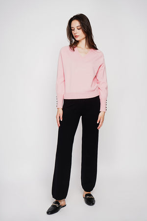 Oversized V-neck sweater with button placket at the bottom of the long sleeves