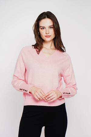 Oversized V-neck sweater with button placket at the bottom of the long sleeves