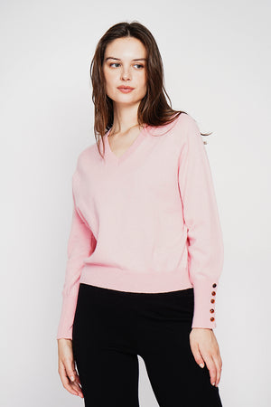 Oversized V-neck sweater with button placket at the bottom of the long sleeves