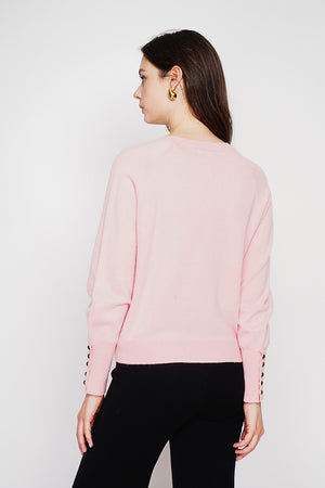 Oversized V-neck sweater with button placket at the bottom of the long sleeves
