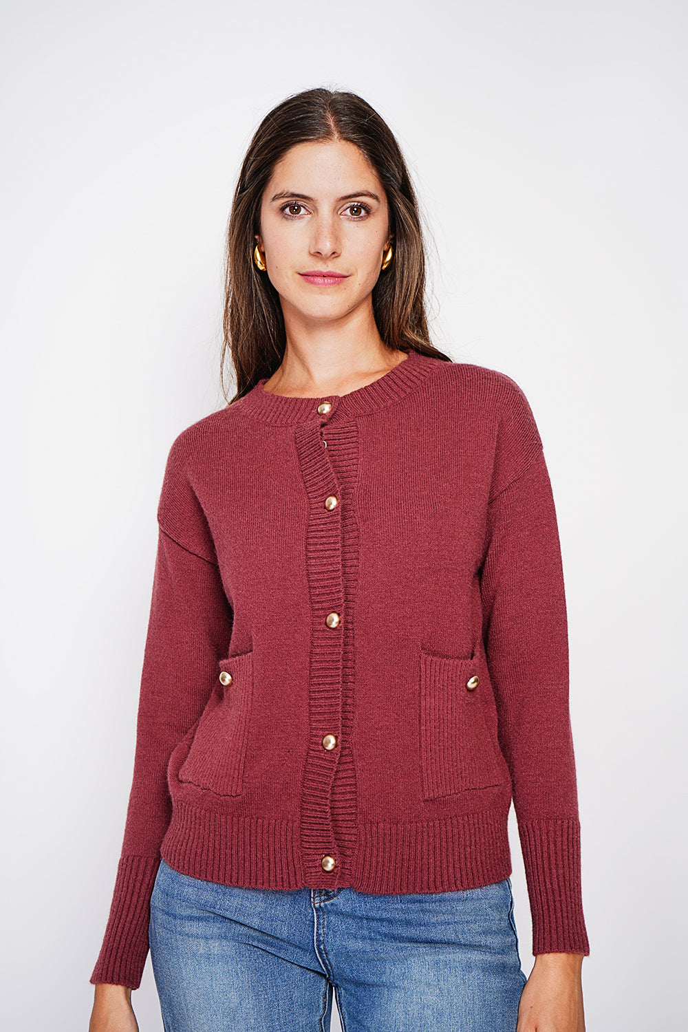 Crew neck vest with fancy buttoned front pockets and long sleeves