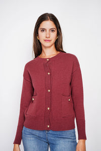 Crew neck vest with fancy buttoned front pockets and long sleeves