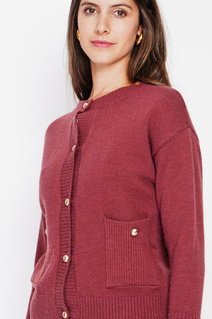 Crew neck vest with fancy buttoned front pockets and long sleeves