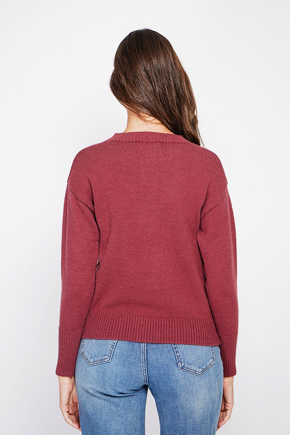 Crew neck vest with fancy buttoned front pockets and long sleeves