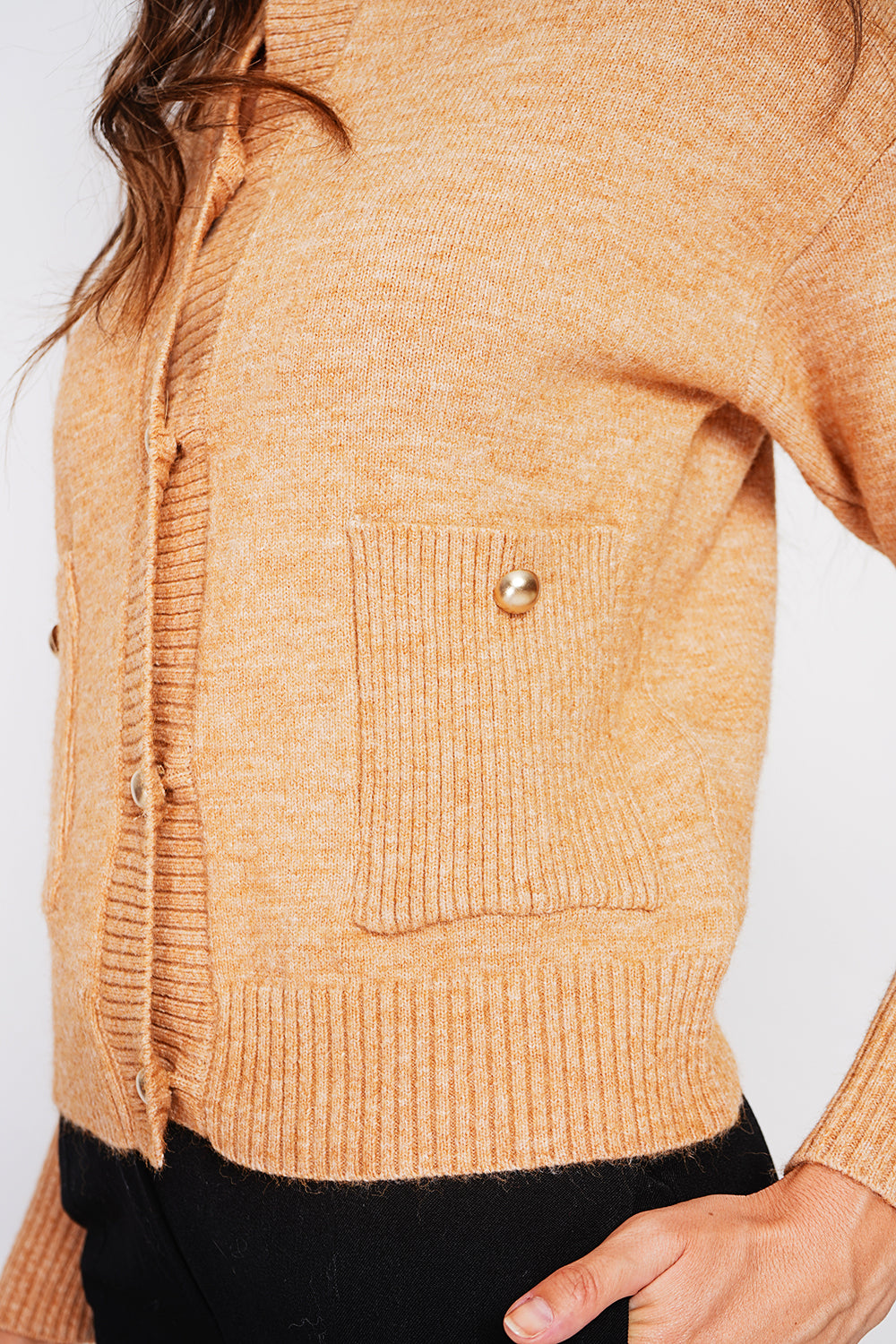 Crew neck vest with fancy buttoned front pockets and long sleeves