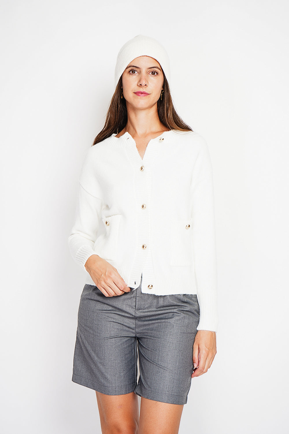 Crew neck vest with fancy buttoned front pockets and long sleeves