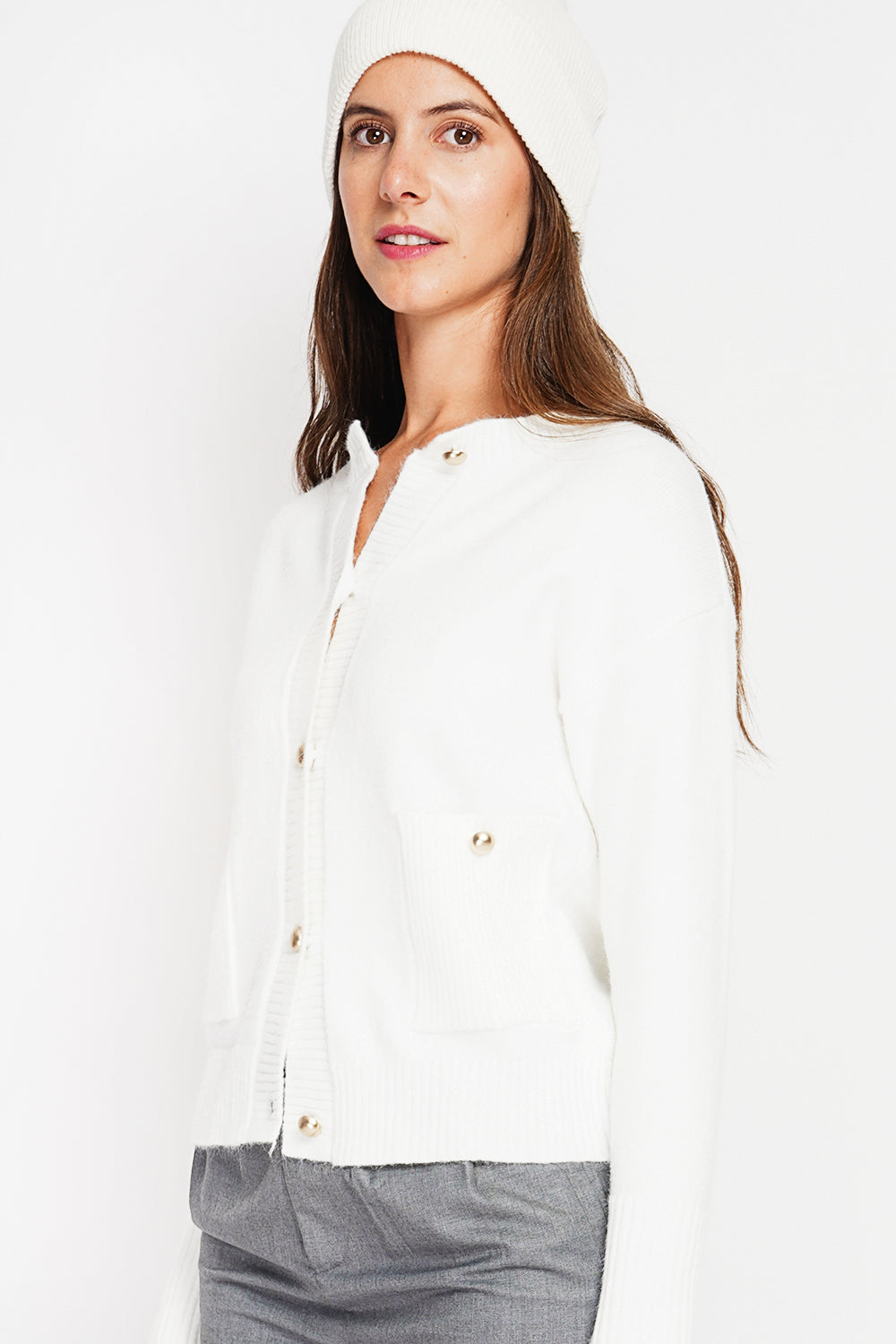 Crew neck vest with fancy buttoned front pockets and long sleeves