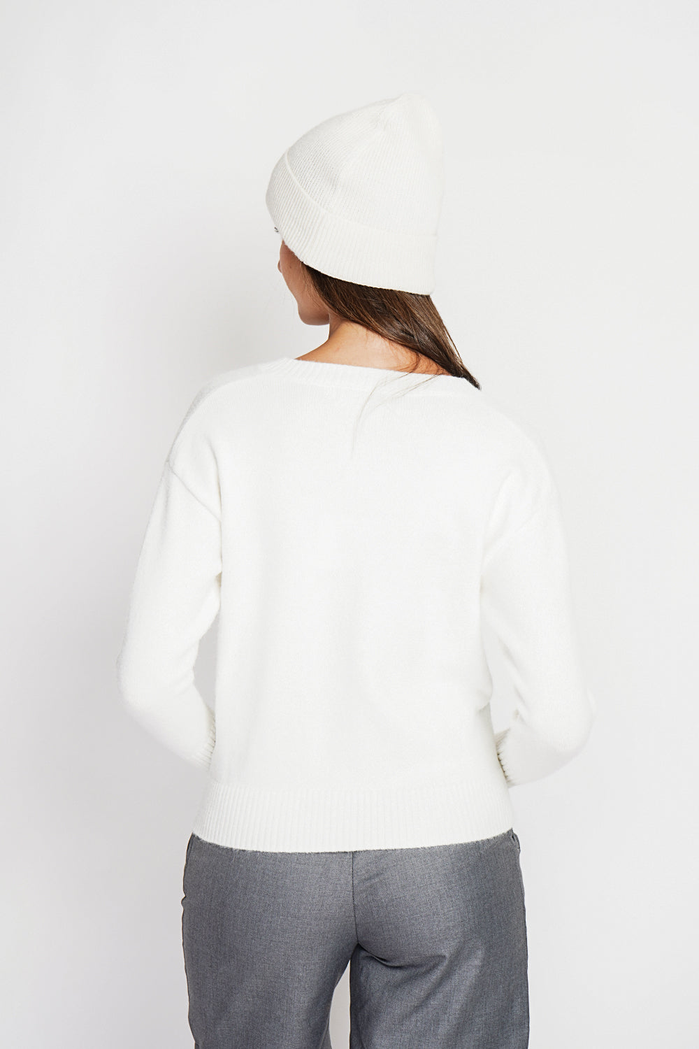 Crew neck vest with fancy buttoned front pockets and long sleeves